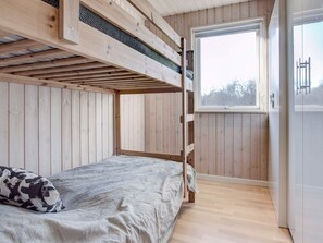 A bunk bed room with a window and a door. - 5 Star Holiday Home in Vejby (Vejby)