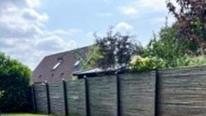 A residential property with a paved driveway, a wooden fence, and a grassy lawn. - 5 Person Holiday Home in Gilleleje (Gilleleje)