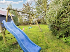 A playground with a blue slide, swings, and a climbing structure. - 7 Person Holiday Home in Vestervig (Vestervig)