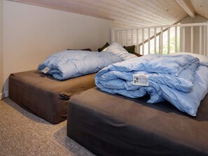 A bedroom with two beds, each with a brown mattress and a blue blanket. - 5 Star Holiday Home in Hadsund (Hadsund)
