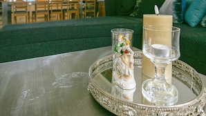 A dining area with a table set for two, featuring a candle and a glass. - 4 Star Holiday Home in Asperup (Middelfart)