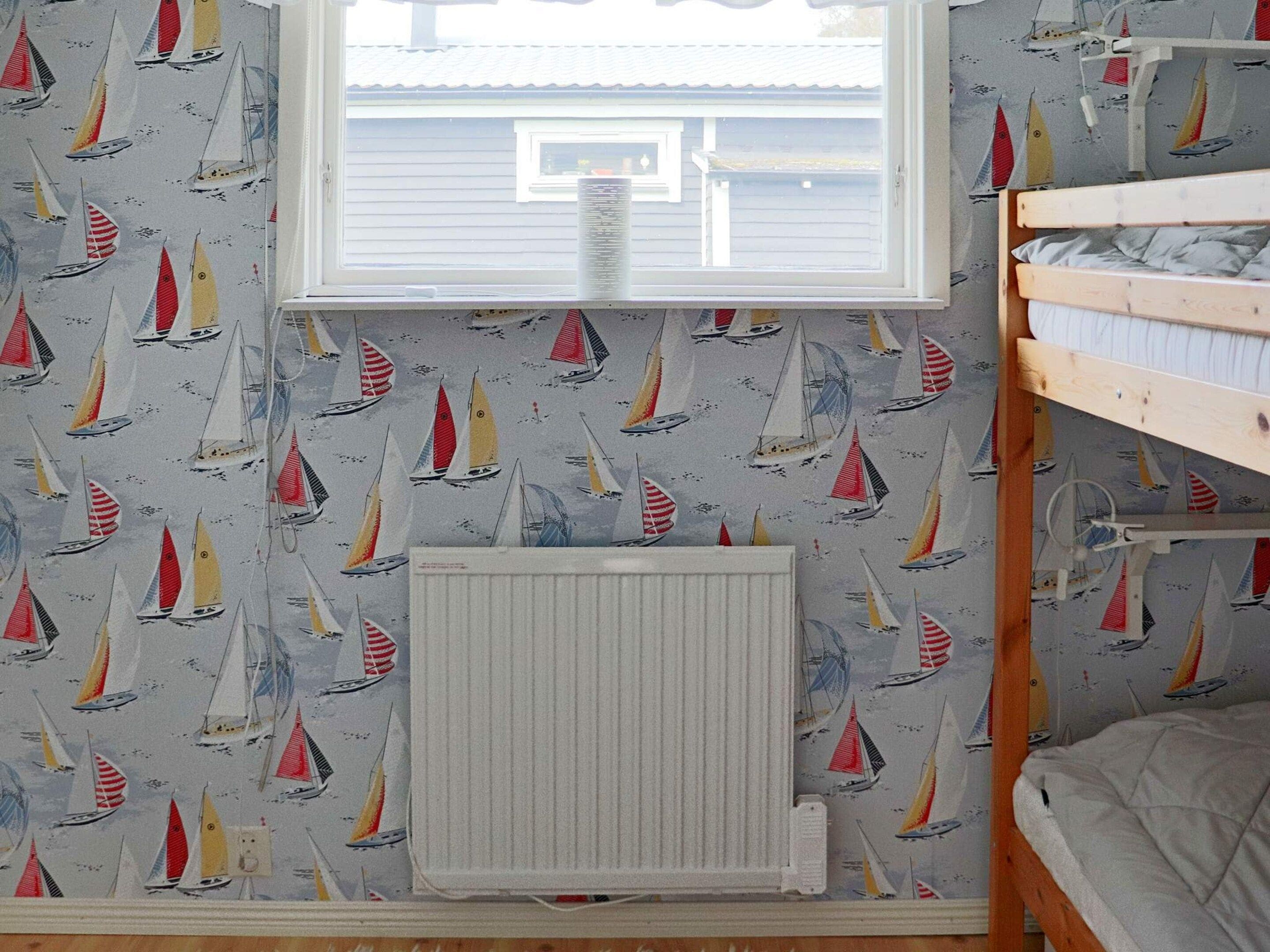 A room with a window, a radiator, and a bunk bed.