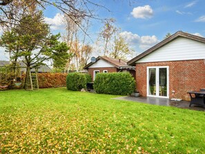 A residential house with a brick exterior, a white door, and a covered patio area. - 4 Person Holiday Home in Sydals (Sydals)