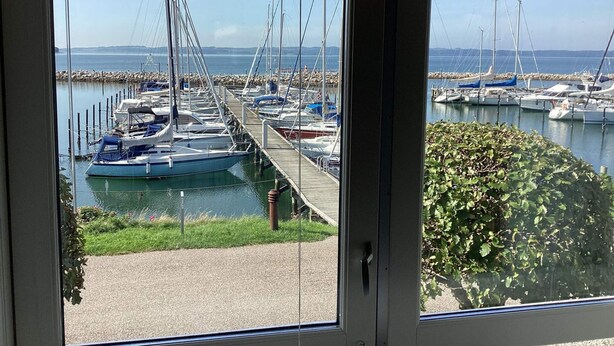 A marina with boats docked and a wooden pier extending into the water. - 4 Star Holiday Home in Ebeltoft (Ebeltoft)