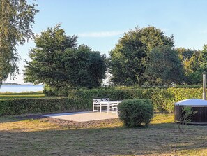 A park with a white gazebo, a small bush, and a metal structure. - 5 Person Holiday Home in Stubbekobing (Stubbekobing)