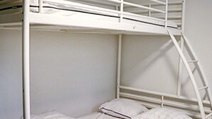 A bunk bed with white bedding and a ladder. - 4 Star Holiday Home in Ullared (Ullared)