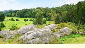 A rural landscape with rolling hills, a grassy field, and a wooden fence. - 4 Star Holiday Home in Rabbalshede (Rabbalshede)