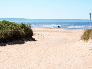 A sandy beach path leading to the ocean with a clear sky. - 6 Person Holiday Home in Skummeslovsstrand (Skummesloevsstrand)