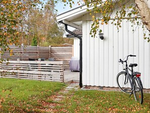 A covered outdoor seating area with a bicycle parked nearby. - 6 Person Holiday Home in Skummeslovsstrand (Skummesloevsstrand)