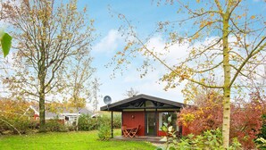 A house with a red exterior, a satellite dish, and a lawn. - 6 Person Holiday Home in Sydals (Sydals)