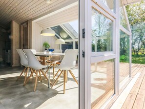 A modern dining area with a table, chairs, and pendant lights. - 6 Person Holiday Home in Karrebaeksminde (Karrebæksminde)