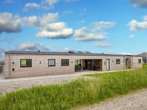 A modern building with a flat roof, large windows, and a covered outdoor area. - 5 Star Holiday Home in Lemvig (Lemvig)