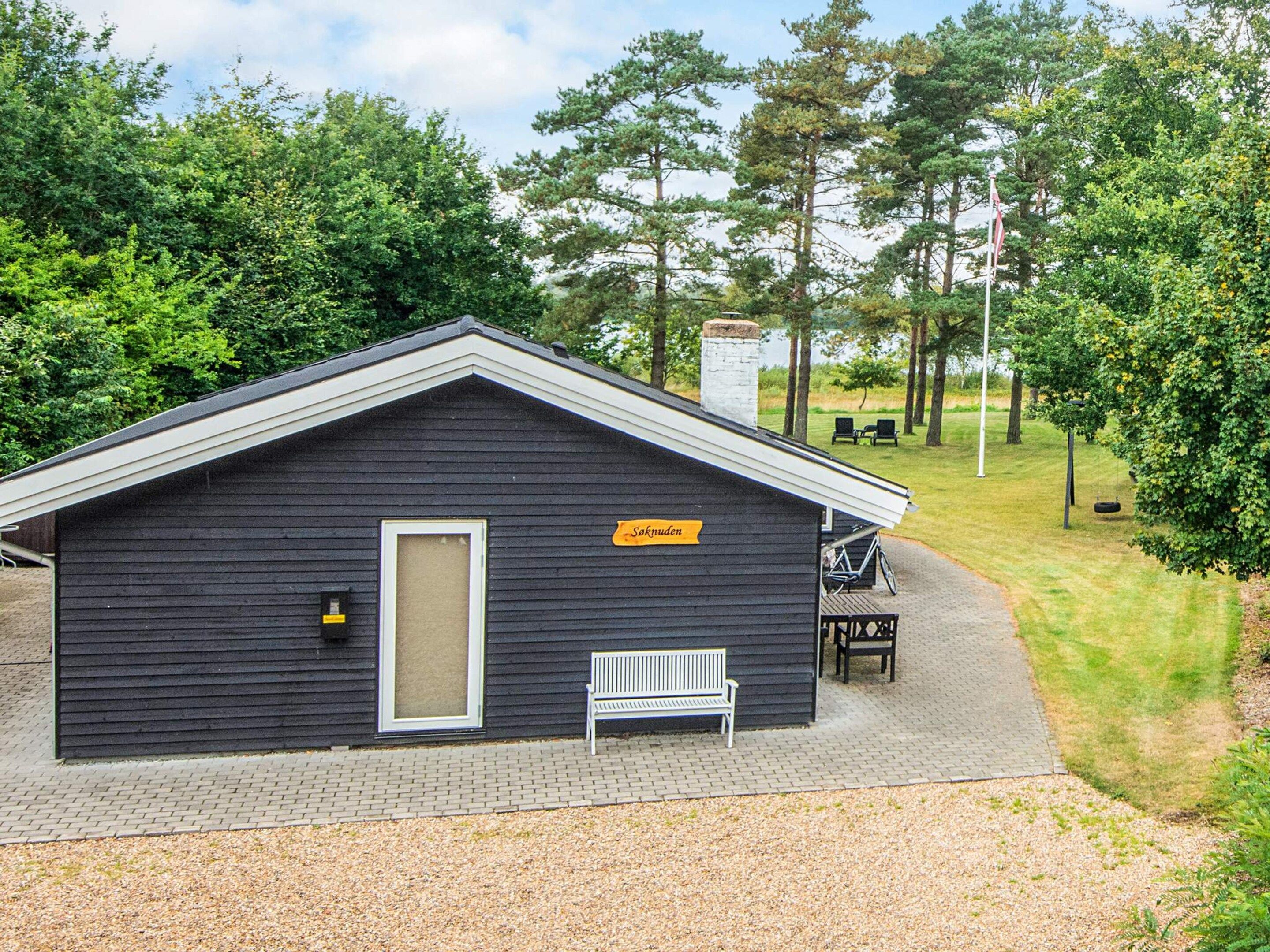 A small cabin with a bench and a bicycle parked outside.