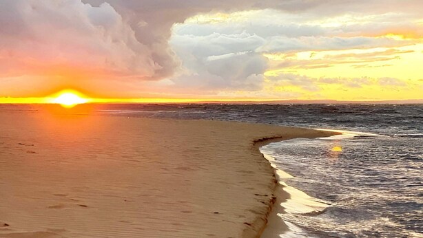 A beach with a sunset and clouds. - 4 Star Holiday Home in Laholm-by Traum (Laholm)