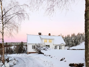 A snow-covered house with a white exterior, a visible chimney, and a small porch area. - 5 Person Holiday Home in Grimstad-by Traum (Grimstad)
