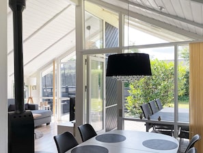 A modern interior with a large glass door leading to an outdoor patio area. - 4 Star Holiday Home in Nordborg (Nordborg)