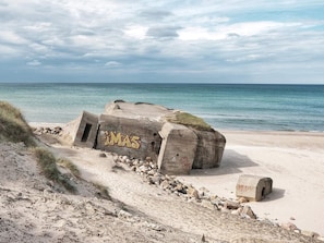 A concrete structure with graffiti on a beach. - 5 Star Holiday Home in Lokken (Lokken)