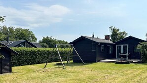 A residential area with multiple cabins, a swing set, and a grassy yard. - 6 Person Holiday Home in Struer (Struer)