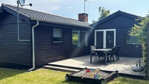 A wooden cabin with a deck, a satellite dish, and a chimney. - 6 Person Holiday Home in Struer (Struer)