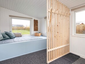 A room with a window seat, a wooden partition, and a view of the outdoors. - 6 Person Holiday Home in Haderslev (Haderslev)