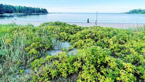 A natural landscape with a body of water, dense greenery, and a clear sky. - 4 Star Holiday Home in Vaddo (Väddö)