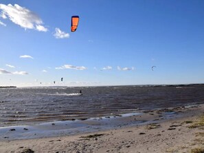 A beach with a clear sky and a body of water. - 6 Person Holiday Home in Bogense (Bogense)