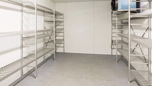 A storage room with metal shelving units and a blue cabinet. - 3 Person Holiday Home in Flatraket (Stad)