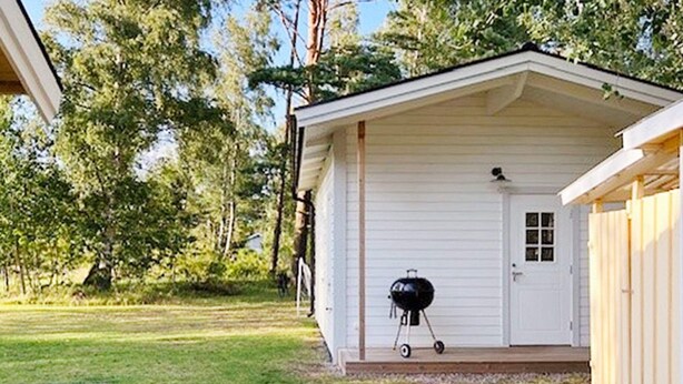 A single-story building with a porch, a door, and a barbecue grill. - 6 Person Holiday Home in Mellbystrand (Mellbystrand)