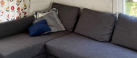 A sectional sofa with a cushion and a pillow.