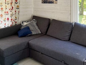 A sectional sofa with a cushion and a pillow. - 6 Person Holiday Home in Mellbystrand (Mellbystrand)