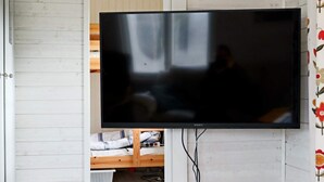 A television mounted on a wall with a wooden bed below. - 6 Person Holiday Home in Mellbystrand (Mellbystrand)