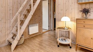 A wooden interior with a staircase, a lamp, and a wooden cabinet. - 4 Star Holiday Home in Albaek (Aalbaek)