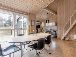 A modern interior with a dining area, kitchen, and living space. - 4 Star Holiday Home in Albaek (Aalbaek)