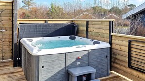 A hot tub with a wooden deck and a small step for access. - 4 Star Holiday Home in Albaek (Aalbaek)