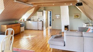 A spacious loft with a kitchen, dining area, and living room. - 4 Star Holiday Home in Solvesborg-by Traum (Sölvesborg)
