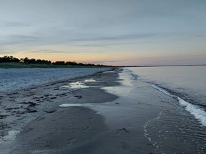 A beach with wet sand and gentle waves. - 4 Star Holiday Home in Vaeggerlose (Vaeggerlose)