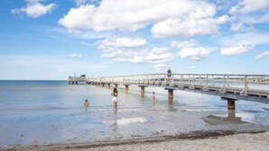 A pier extending into calm waters with a clear sky above. - 4 Star Holiday Home in Kopingsvik (Kopingsvik)