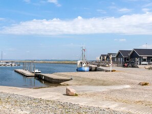 A coastal marina with boats docked, a pier, and a building with outdoor seating. - 5 Star Holiday Home in Vinderup (Vinderup)