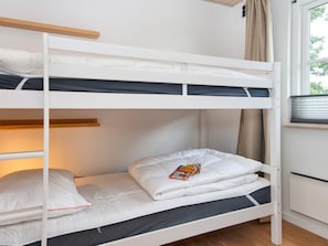 A bunk bed with a window view, a radiator, and a curtain. - 5 Star Holiday Home in Vinderup (Vinderup)