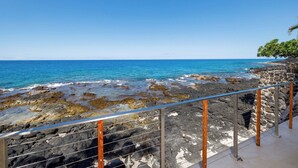 A coastal view with rocky terrain and a clear blue sky. - Hale Kale:Direct Oceanfront Masterpiece,Modern Spectacular One of a Kind Home (KAILUA KONA)