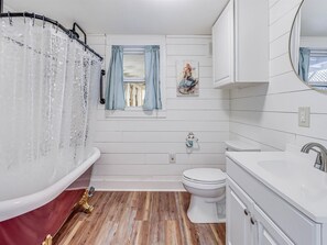 Enjoy a relaxing soak in the bathtub, paired with a sink and mirror.