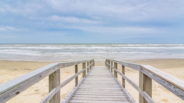 A wooden boardwalk leading to a beach with waves in the background. - Serene Surfside Beach Retreat w/ Ocean Views! (Freeport)