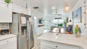 A modern kitchen with stainless steel appliances, a marble countertop, and a central island. - Serene Surfside Beach Retreat w/ Ocean Views! (Freeport)