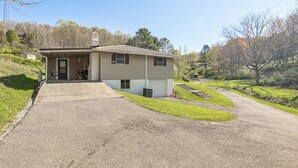 A single-story house with a covered porch, a driveway, and a grassy yard. - Home w/ Bunkroom: 2 Mi to Hatfield & Mccoy Trail (Bluefield)