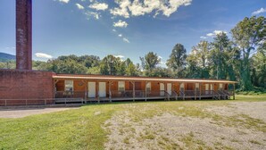 A brick building with a wooden deck and multiple rooms. - ATV Trails & Adventure: Briceville Mountain Studio (Briceville)
