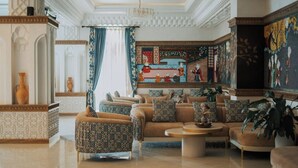 A luxurious lobby with ornate ceiling, patterned walls, and comfortable seating areas. - Kohinur Plaza (Samarkand)