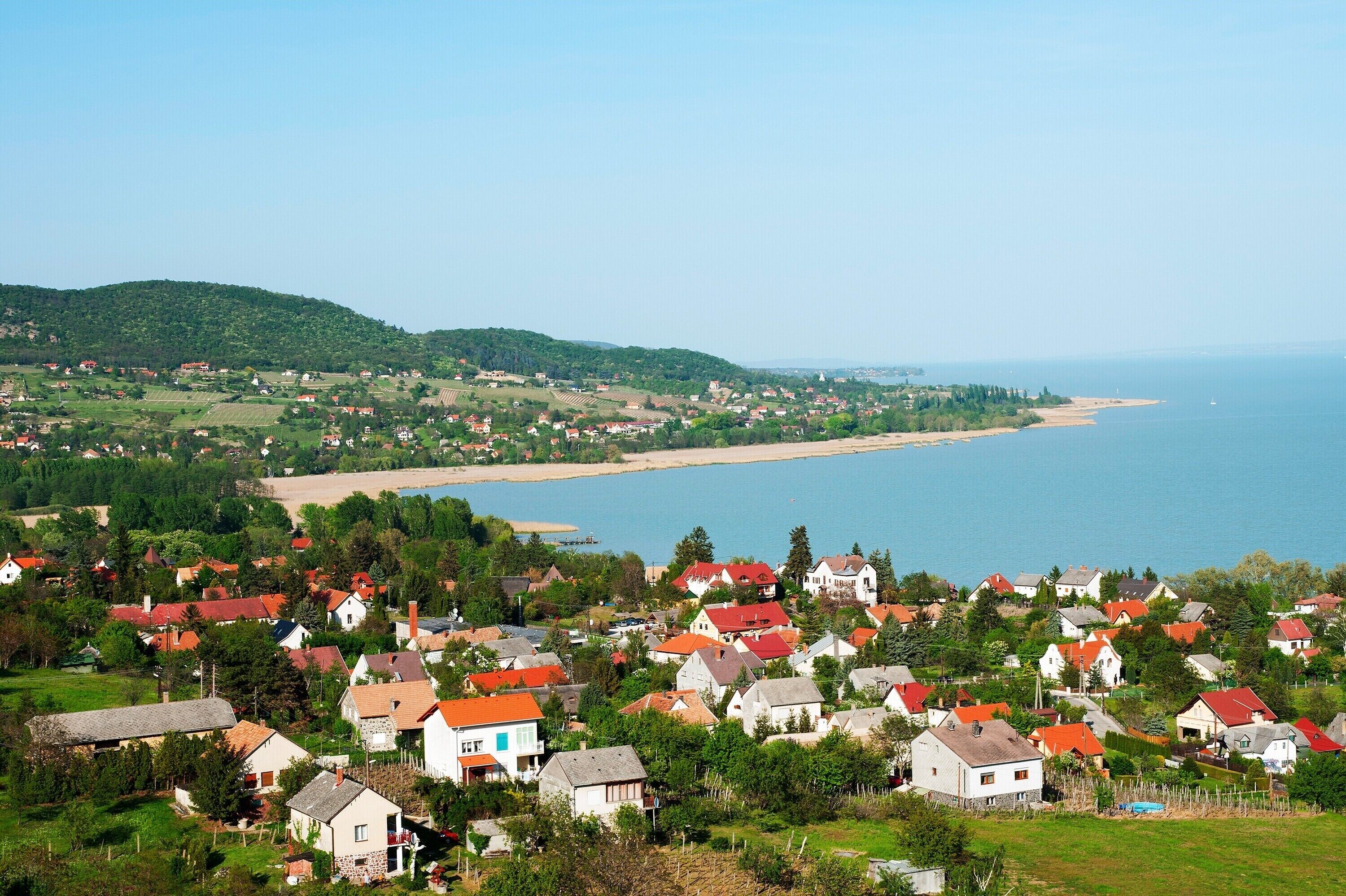 A coastal village with houses and a beach.