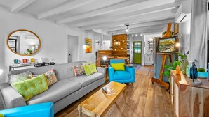 A modern living room with a grey sofa, a blue armchair, and a wooden coffee table.