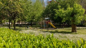 A park with playground equipment, benches, and trees. - The Turin Nest by Wonderful Italy (Torino)
