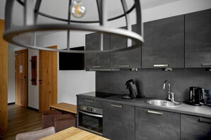 Enjoy cooking in this well-equipped kitchen with oven, modern sink, and stainless steel appliances.
